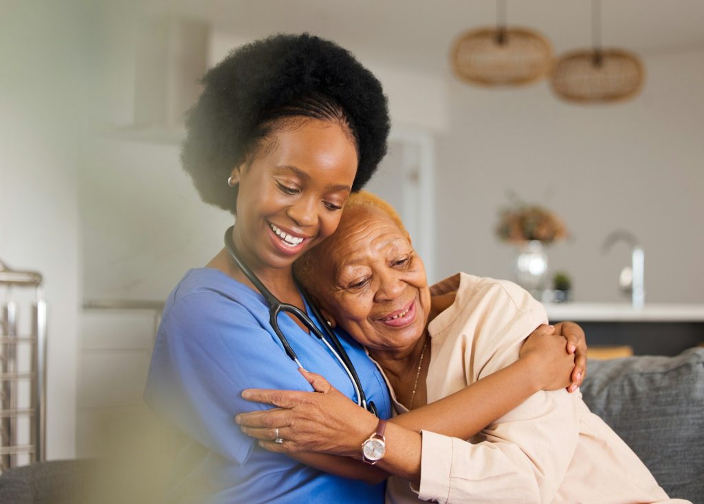 Black people, hug and nurse in elderly care for support, trust or healthcare in old age home. Happy