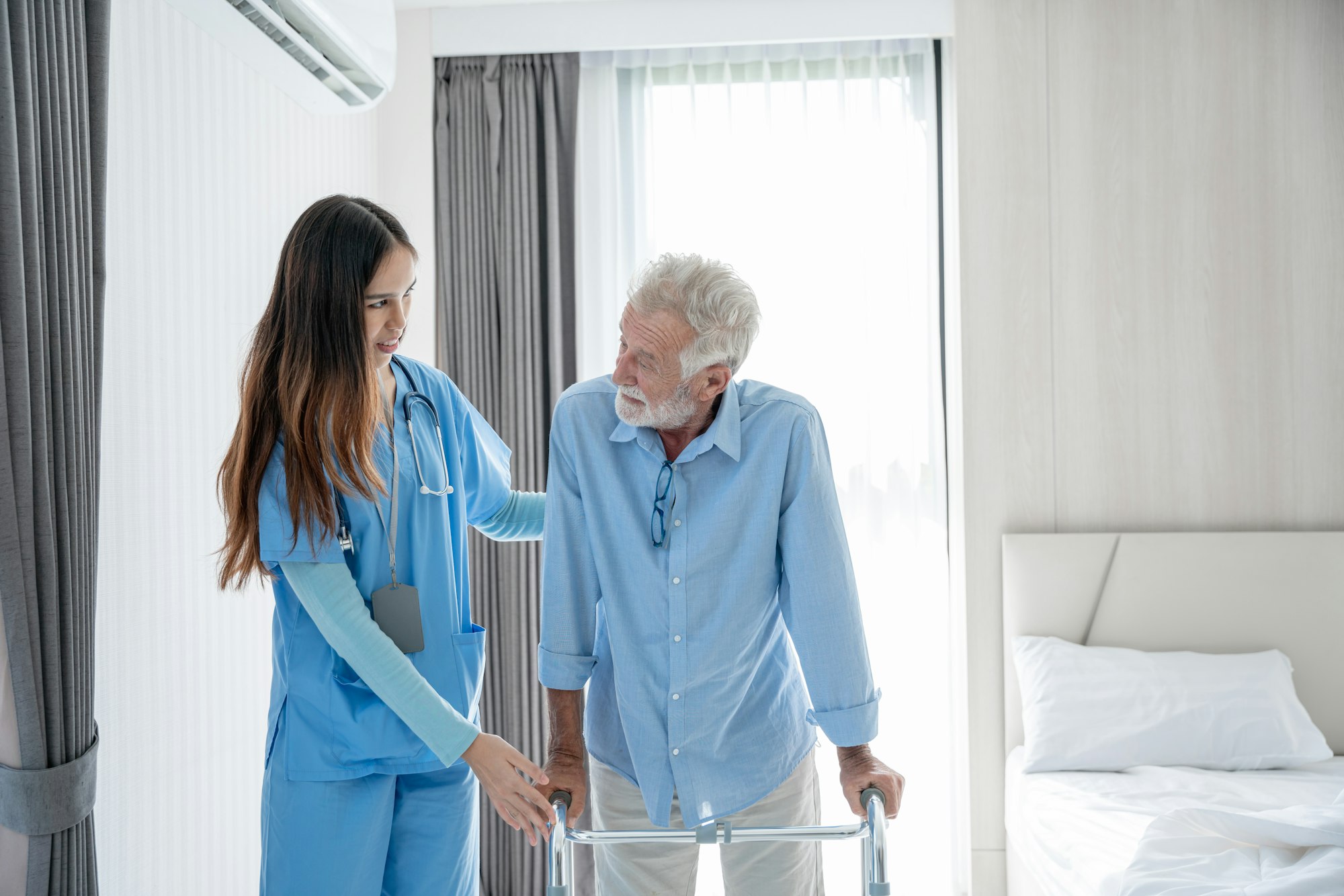 Medical staff taking and caregiver senior man in Home. Home care concept.